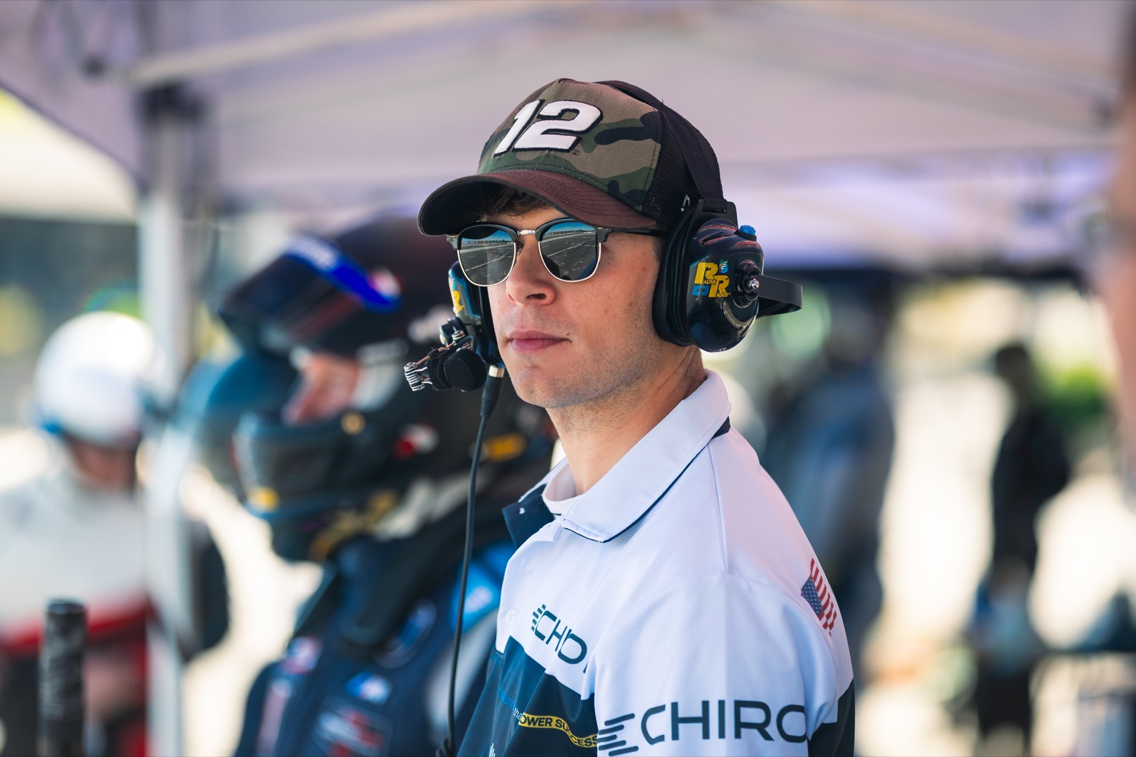 Ren on the pit wall wearing a radio headset
